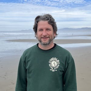 A photo of Chris Erickson at the beach on the central coast of California