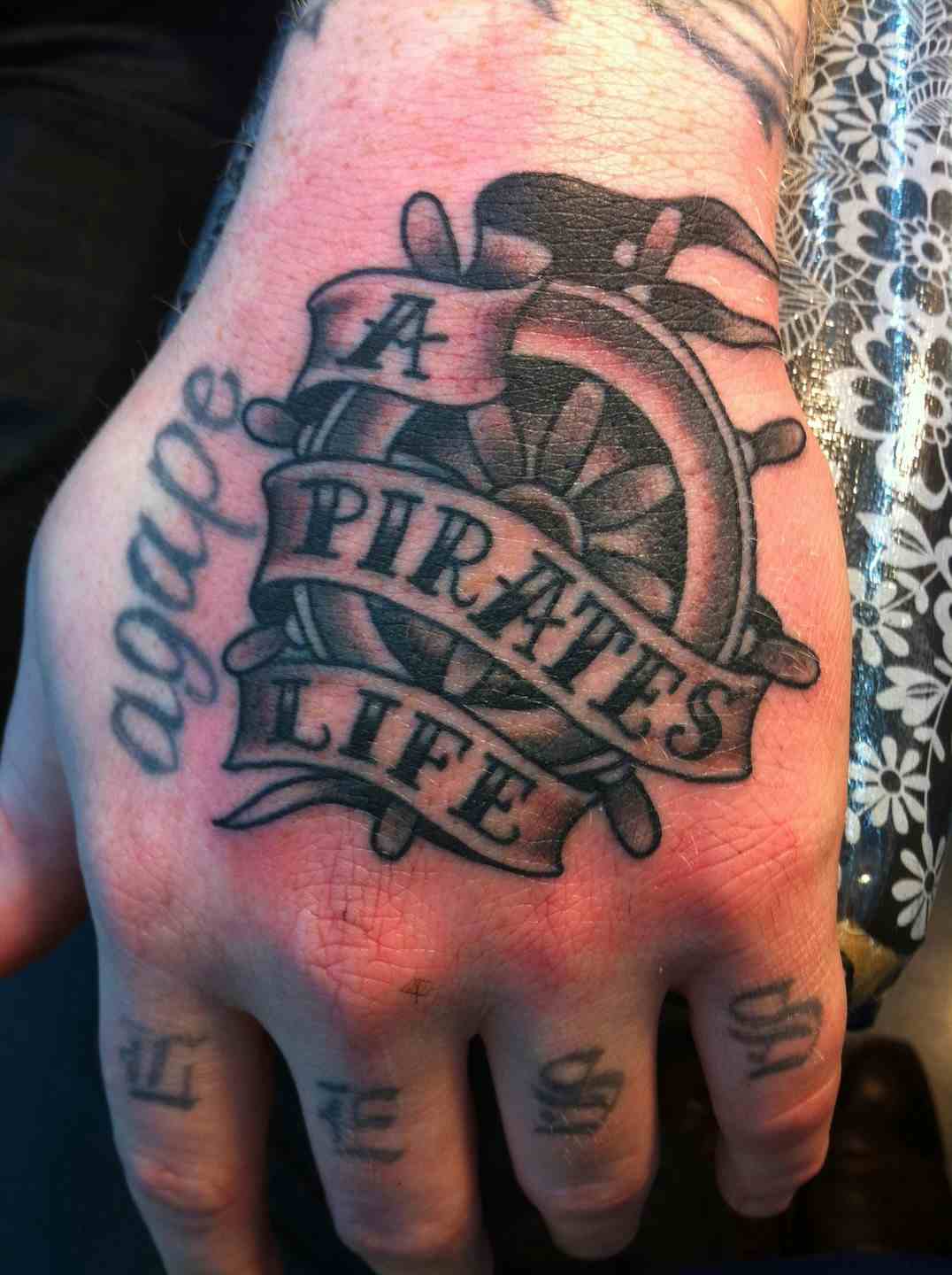 Ship's wheel pirate tattoo