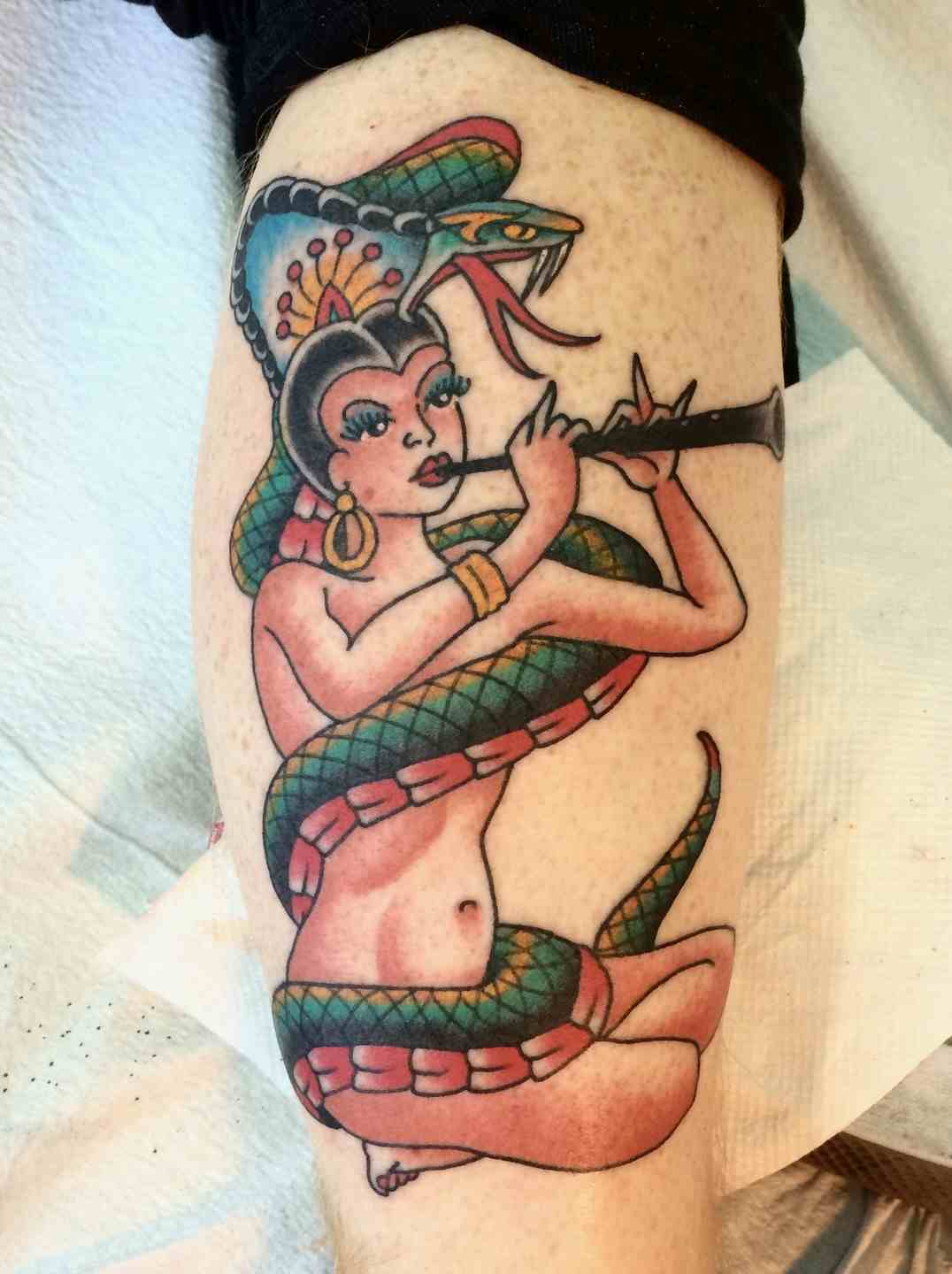 Snake charmer pinup tattoo