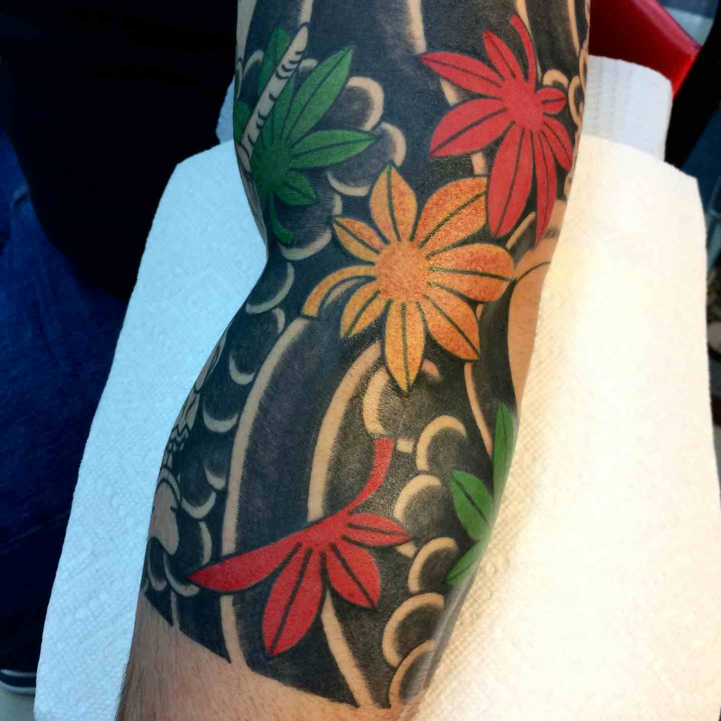 Maple leaf and wind tattoo