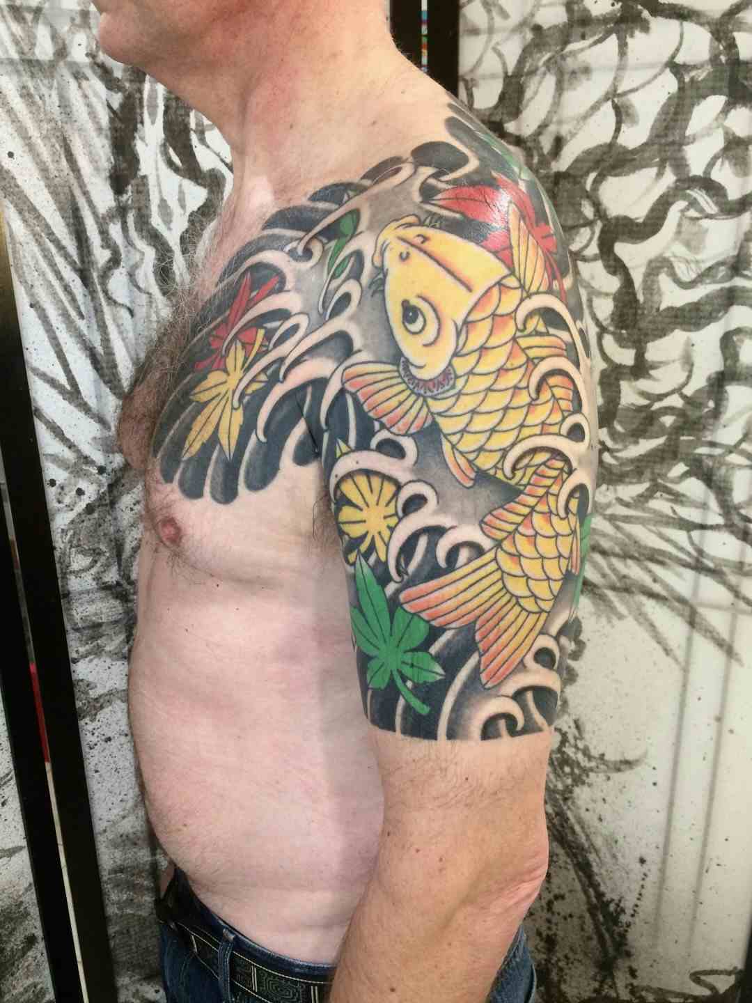 Yellow koi fish and maple leaf tattoo