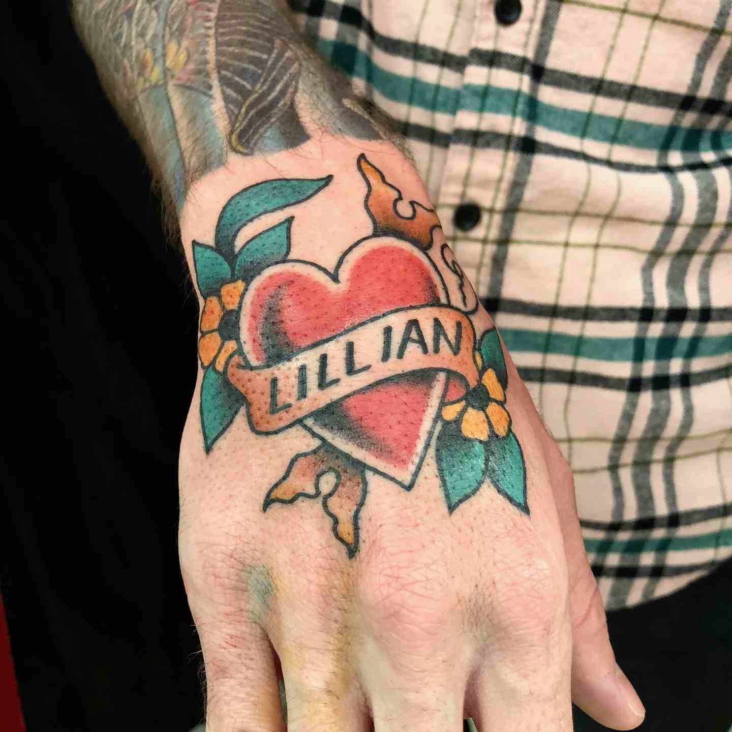 Heart with banner and flowers tattoo