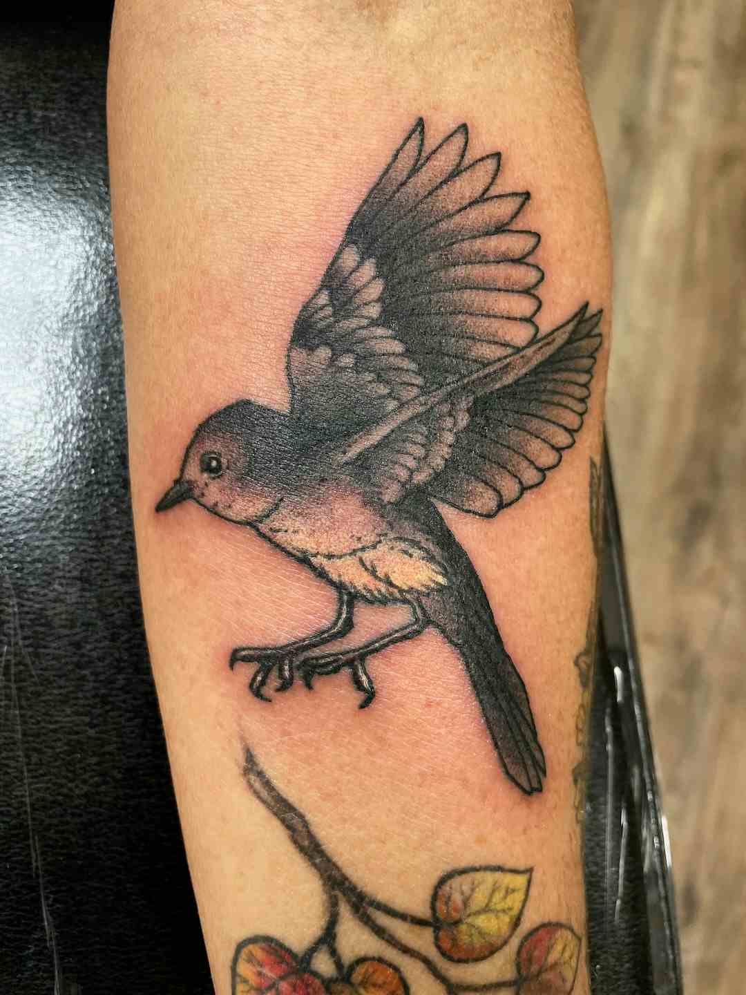 Black and gray small bird tattoo
