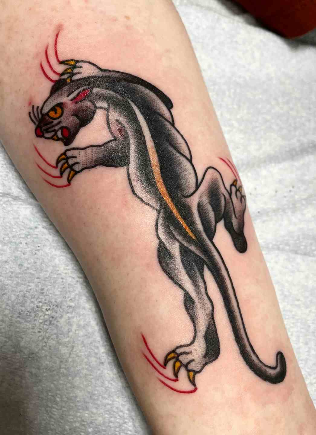 Traditional crawling panther forearm tattoo