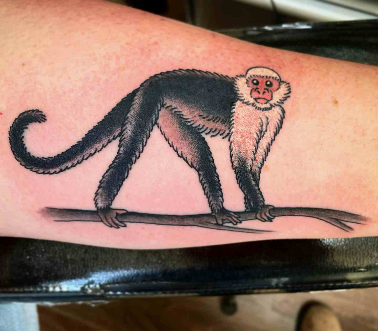 Monkey on a branch tattoo