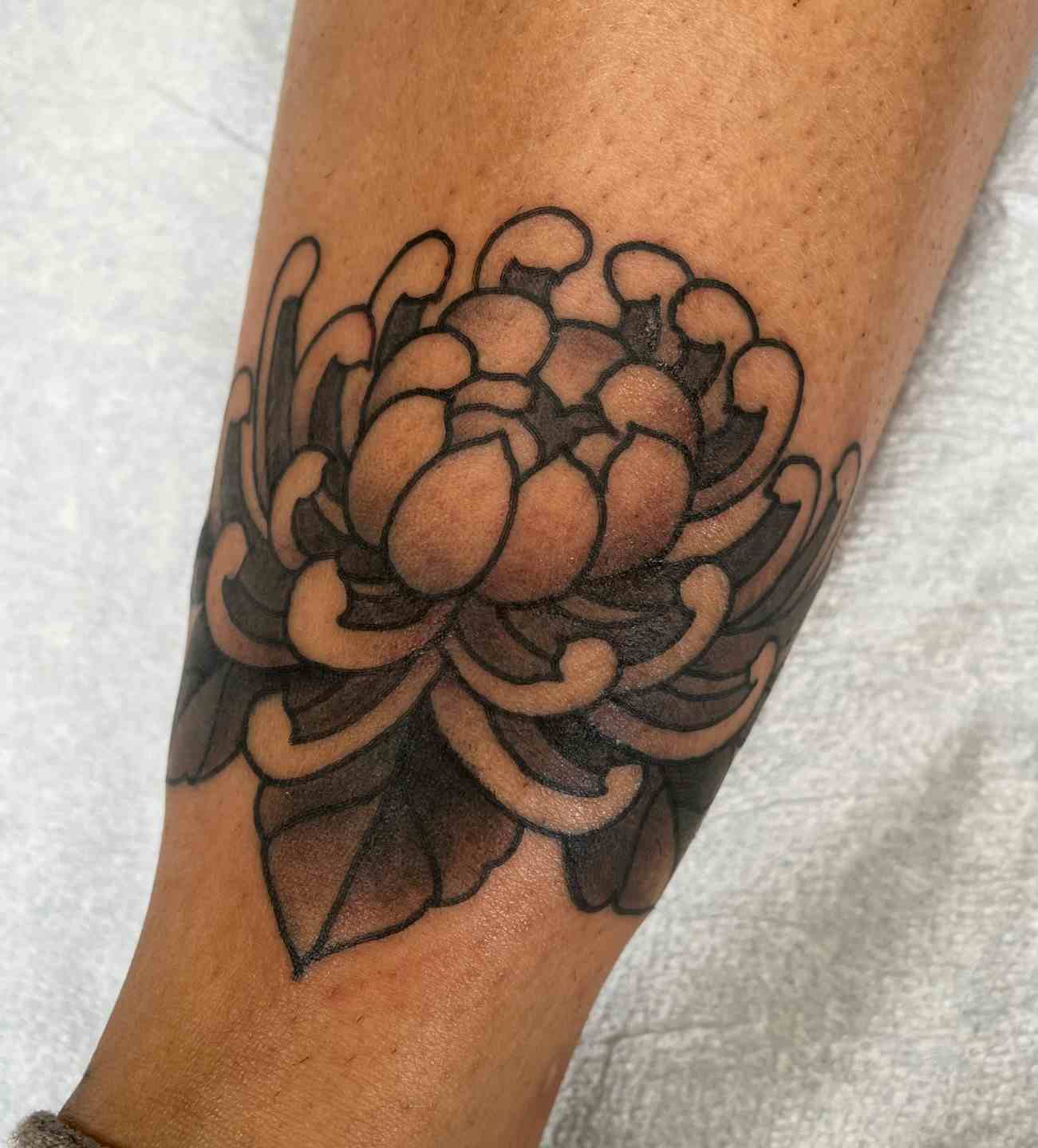 Black and grey chrysanthemum tattoo
