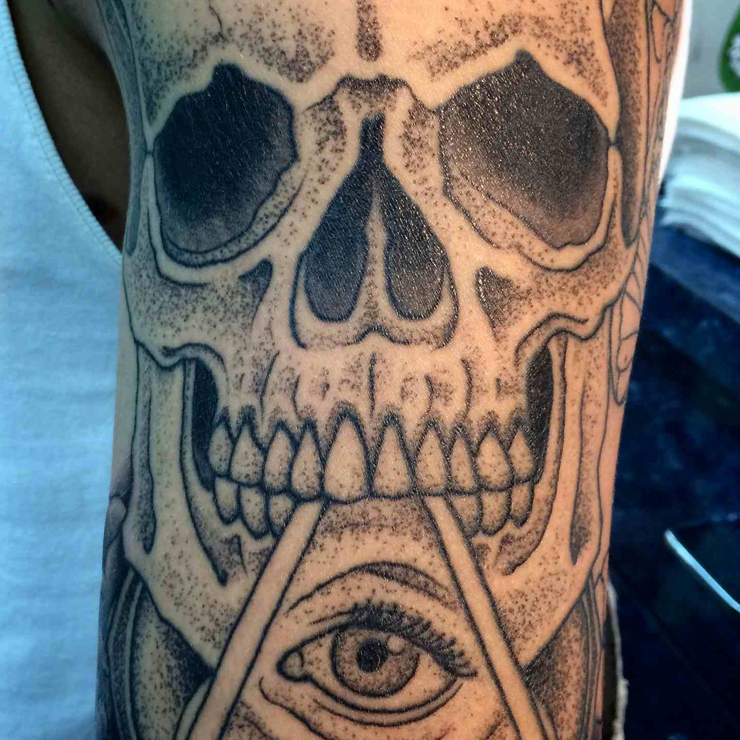 Skull geometric eye sleeve tattoo