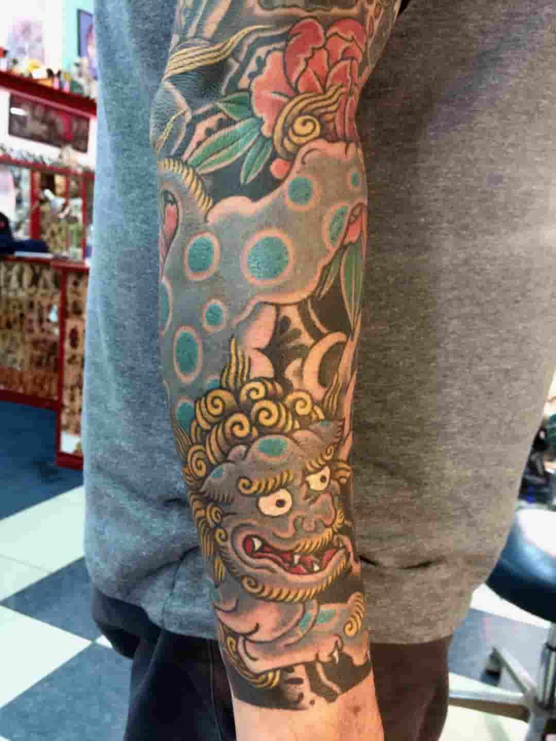 Chinese snow lion sleeve tattoo