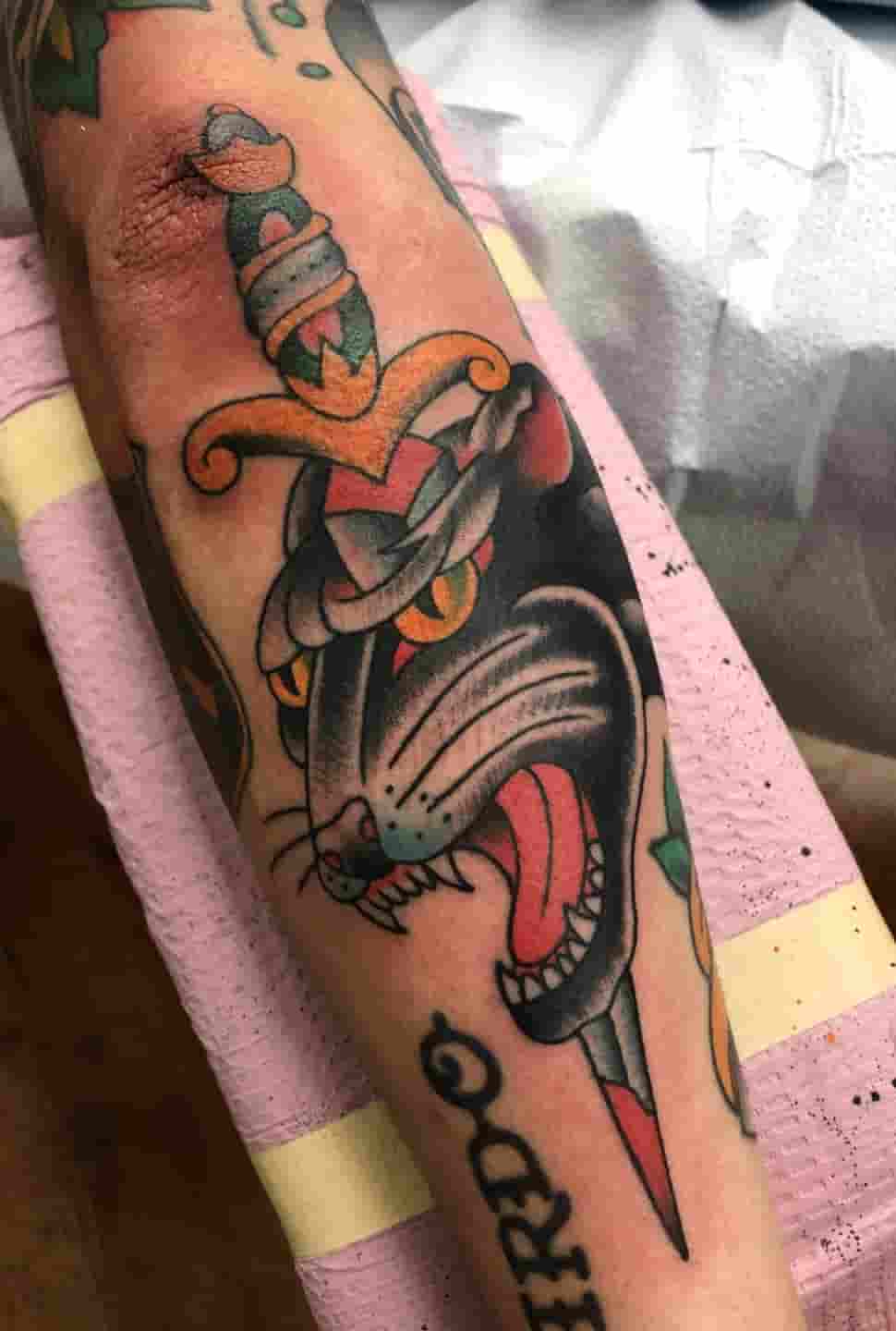 Panther head dagger tattoo