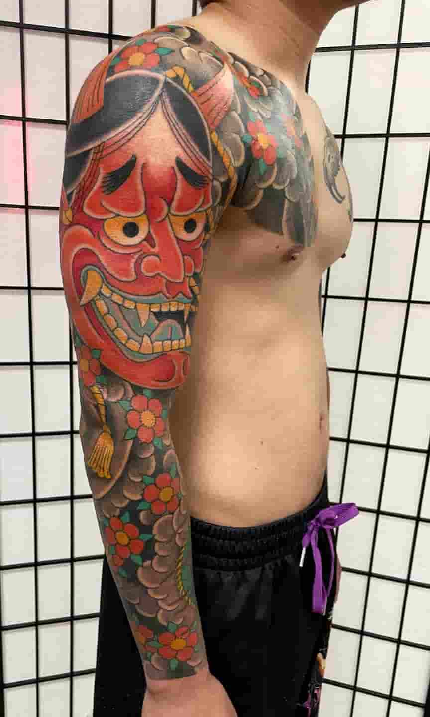 Japanese red hannya mask cherry blossom sleeve tattoo